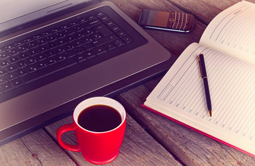 working desk with cup of coffee planner agenda laptop