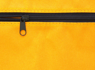 zipper on yellow bag background © aopsan