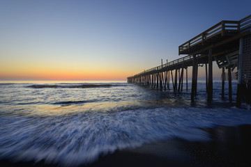 Fishing Pier and Ocean Waves at Sunrise