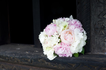 Wedding bouquet in wooden window