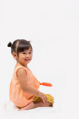 Asian girl with Thai traditional dress playing with toy