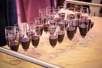 Glasses with red champagne on the party table