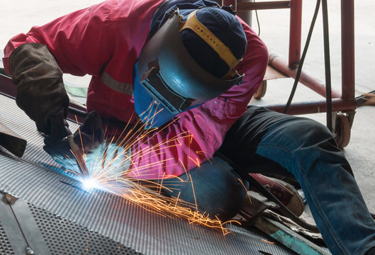 worker in constructing industry welding metal