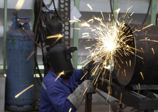 worker in constructing industry grinding metal