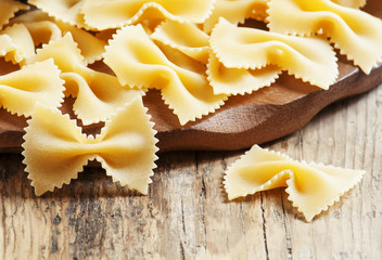 Obraz na płótnie Canvas Dry Italian pasta farfalle, selective focus