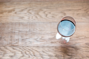 Glasses with red wine on the wooden background