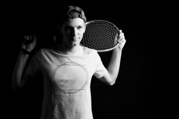 Tennis player on black background. Studio shot