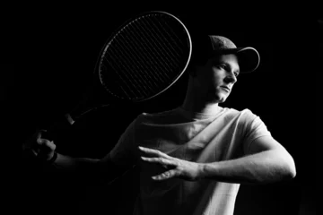 Rolgordijnen Tennis player on black background. Studio shot © fotofabrika