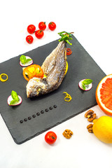 Tasty baked fish on table close-up