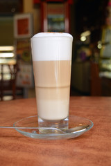 Hot Latte Macchiato In Glass Cup On The Wooden Table    