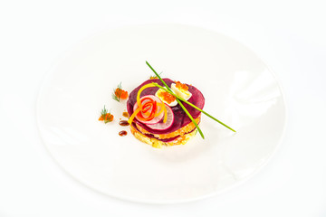 Beetroot salad with carrot, onion, potato, herring, garnish with mayonnaise, spring onion and dill