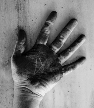 Left hand of a man dirty of charcoal