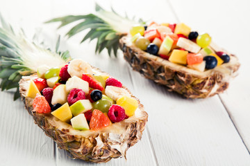 Fresh Fruit Salads in Pineapples on White Table