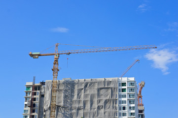 Big crane and construction skyscraper with blue sky