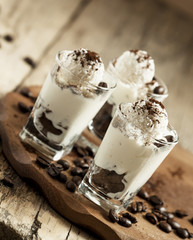 Traditional Italian dessert tiramisu in glass, selective focus