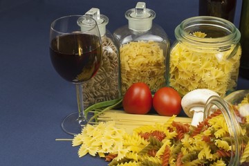 different kinds of pasta on the table, together with vegetables