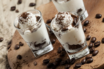 Traditional Italian dessert tiramisu in glass, selective focus