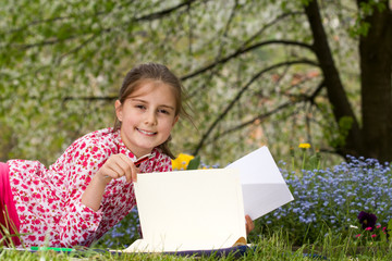 Young girl reading a book outdoor