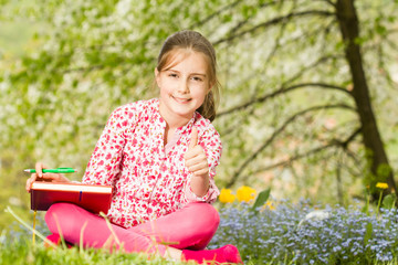 Young girl reading a book outdoor