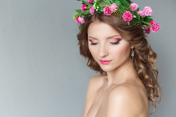 beautiful sexy girl with a wreath of flowers with bare shoulders