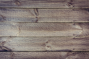 crude fence from horizontal wooden boards with nails