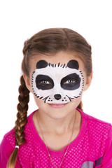 Young girl wearing panda carnival face paint isolated on white