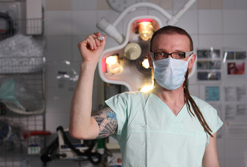 Fototapeta na wymiar Portrait of male nurse ICU with tattoo and dreadlocks.
