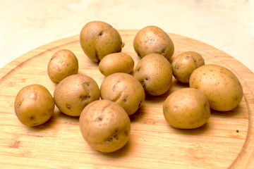 Fresh organic young potatoes laying on a cutting board