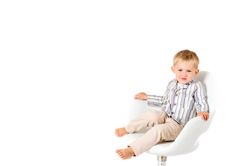 Boy shot in the studio on a white background in chair copy space