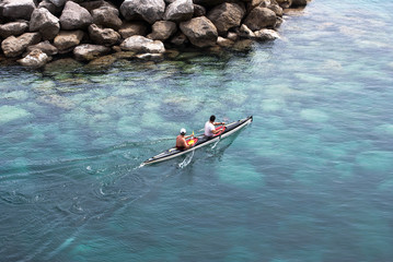 Fototapeta premium Two men padding in a canoe