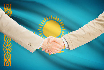 Businessmen handshake with flag on background - Kazakhstan