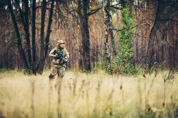soldier with rifle in the forest