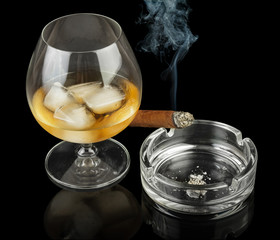 Glass of cognac with cigar