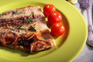 Dish of Pangasius fillet with rosemary and cherry tomatoes in plate
