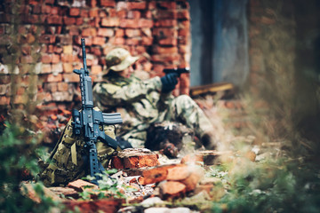 soldier with rifle in the ruins