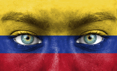 Human face painted with flag of Colombia