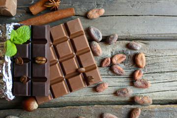 Delicious chocolate with spices on wooden table, closeup