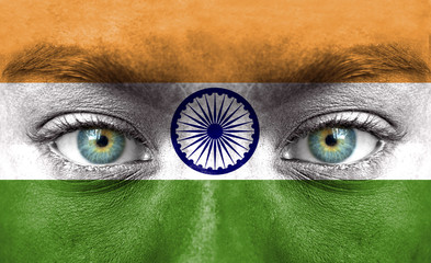 Human face painted with flag of India