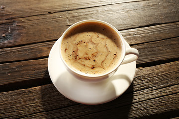Cup of coffee latte art on wooden background