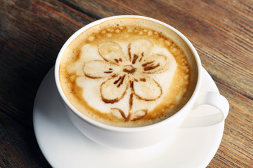 Cup of coffee latte art on wooden background