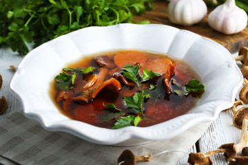 Mushroom soup on wooden table, closeup