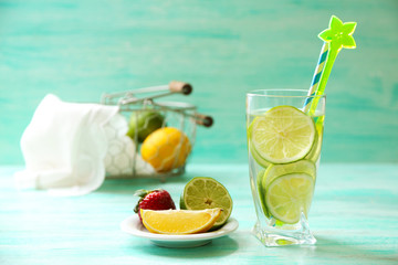 Cocktail with fresh citrus fruits on wooden background