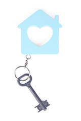 Toy house with key isolated on white