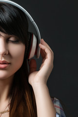 Close-up portrait of young woman listening to music