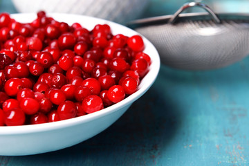 Cranberries in bowl on table close up