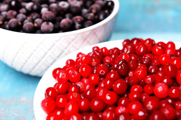 Blackberry with cranberries in bowls close up
