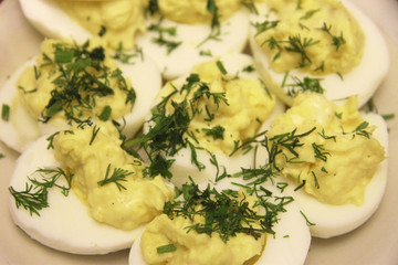 Boiled eggs sliced in halves stuffed and filling by pasta with d