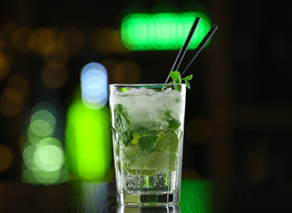 Glass of cocktails on bar background