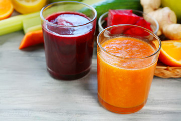 Assortment of healthy fresh juices on wooden table background