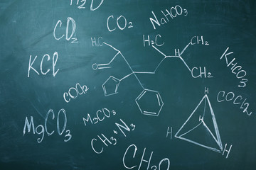 Molecule models and formulas on blackboard background